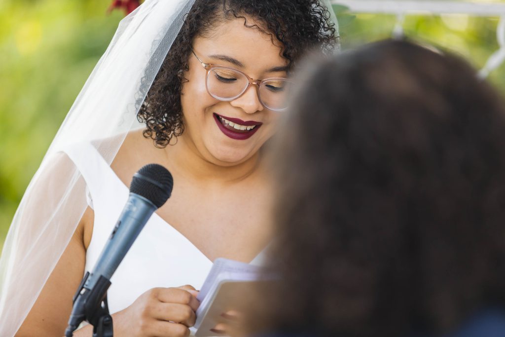A bride laughs during her wedding ceremony.
