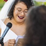 A bride laughs during her wedding ceremony.