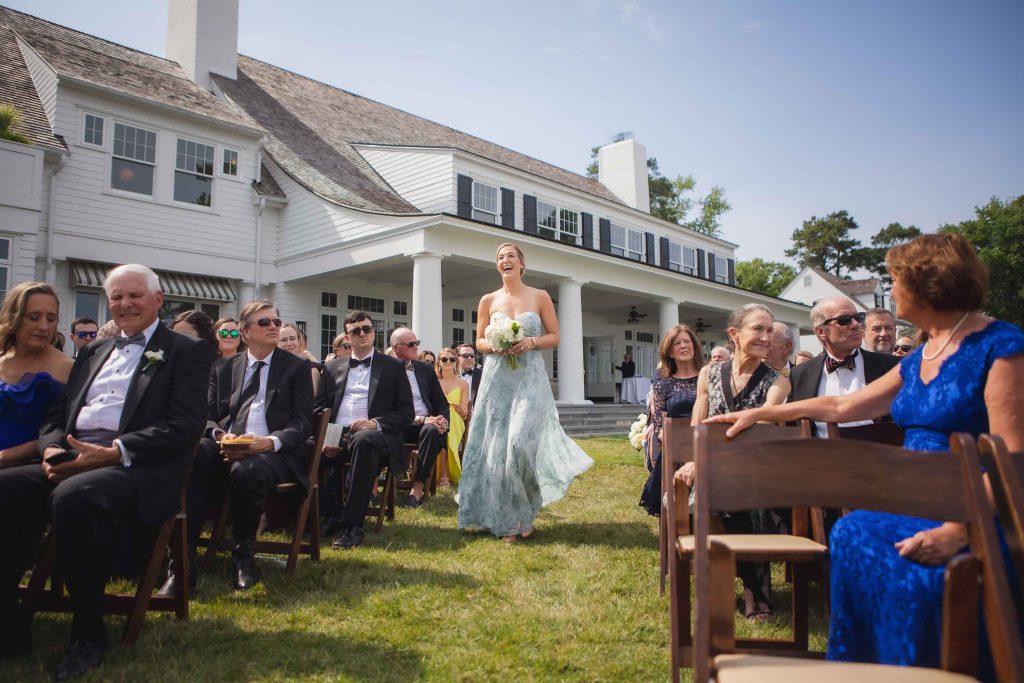 A bride walks down the aisle at a wedding ceremony.