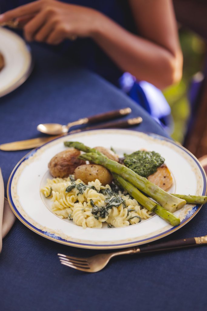 A plate of pasta and asparagus with wedding details.