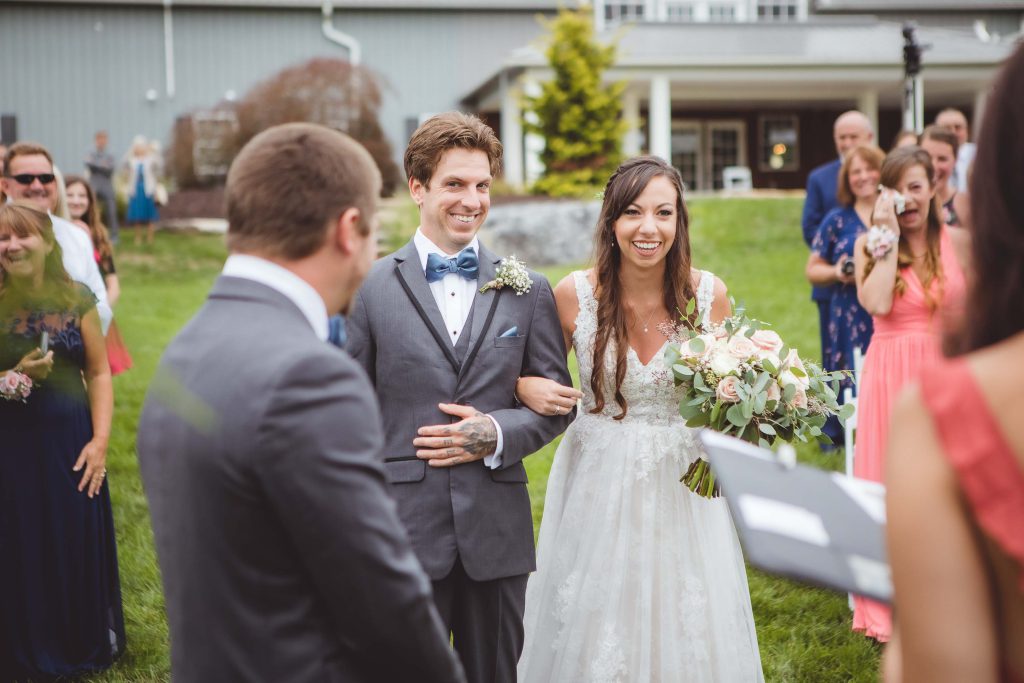 A bride and groom have a ceremony at a farm wedding.