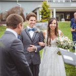 A bride and groom have a ceremony at a farm wedding.