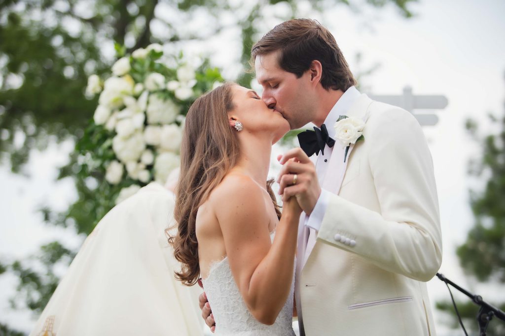 A couple shares a kiss during their wedding ceremony.