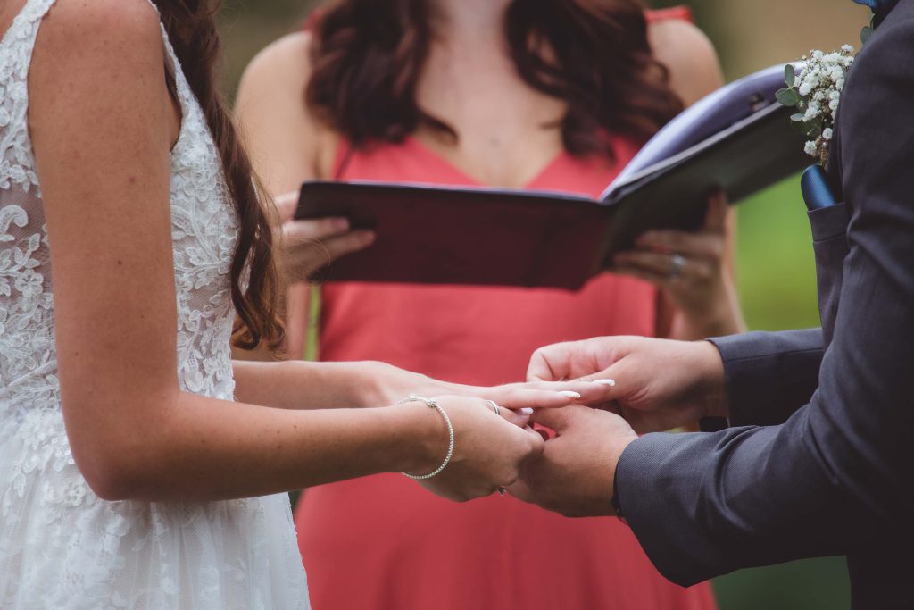 A couple exchanged rings during their wedding ceremony.