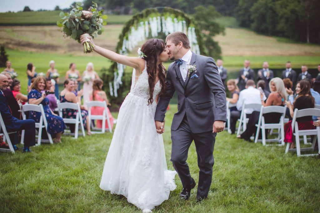A bride and groom sharing a kiss during their wedding ceremony.