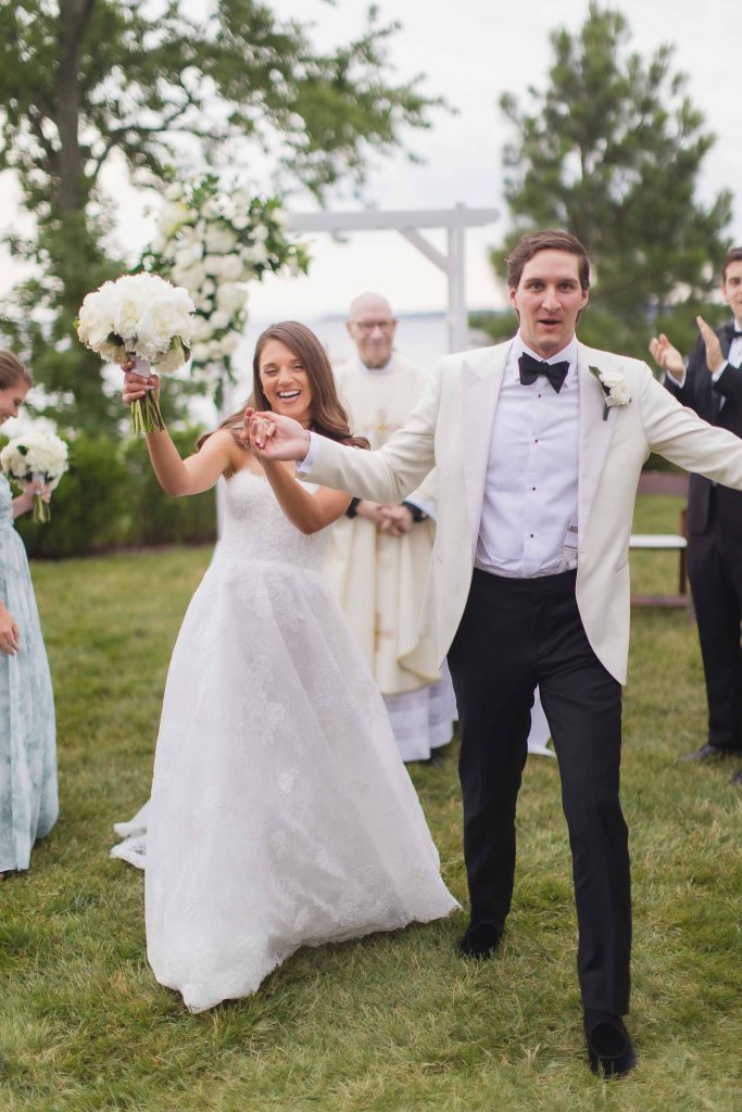 A couple walking down the aisle at their wedding ceremony.