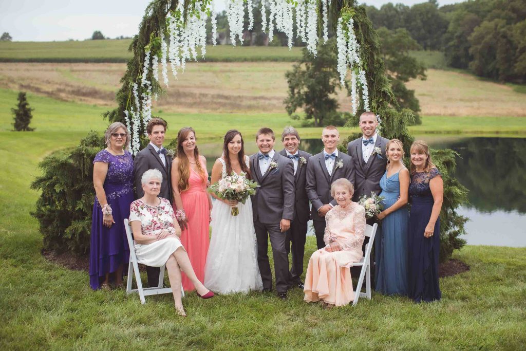 A wedding portrait by a pond.
