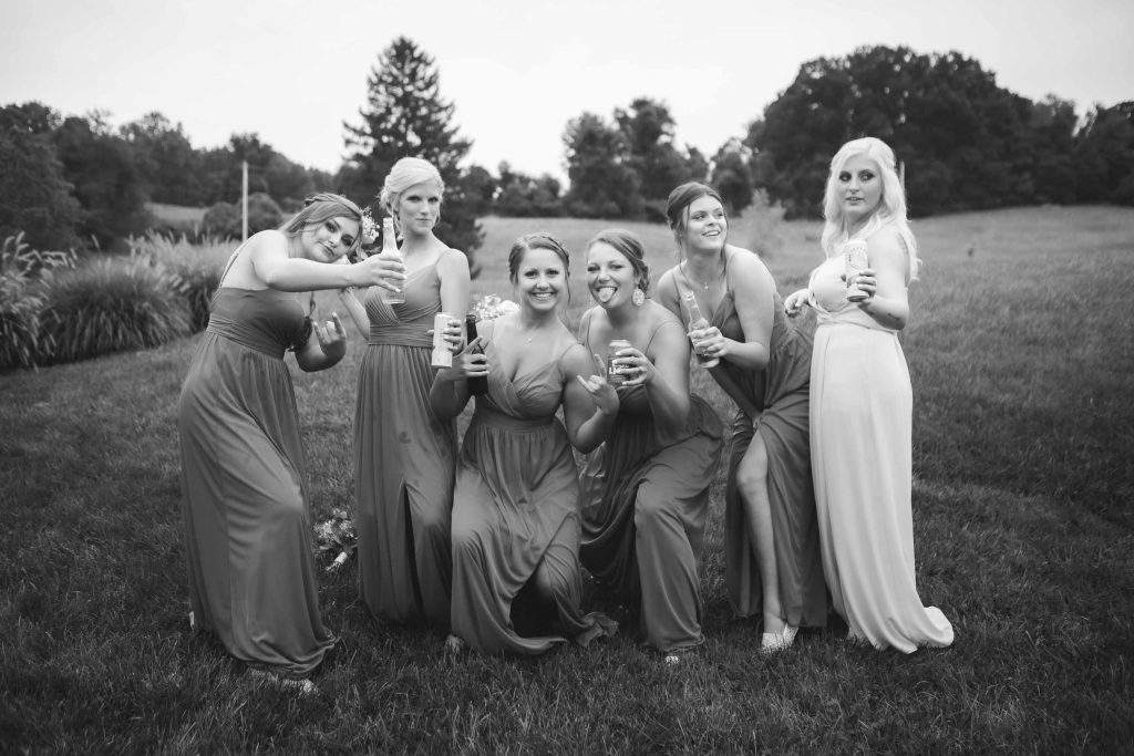 Wedding photo of bridesmaids posing in black and white.