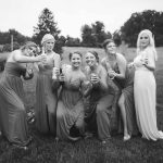 Wedding photo of bridesmaids posing in black and white.