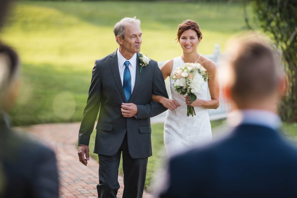 A bride walks down the aisle during her wedding ceremony.