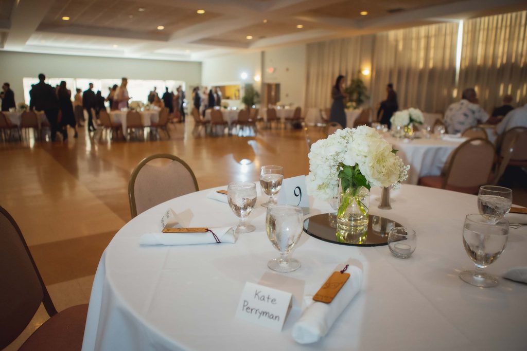 Wedding reception with meticulously arranged tables and chairs.