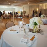 Wedding reception with meticulously arranged tables and chairs.