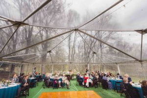 A wedding reception with tables and chairs.