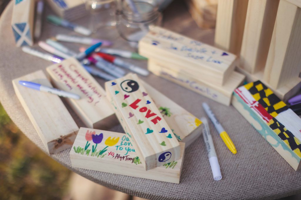 A detailed table display with markers and wooden blocks, perfect for a wedding.