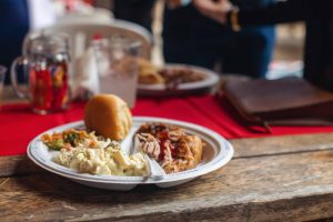 A plate of food on a wooden table.