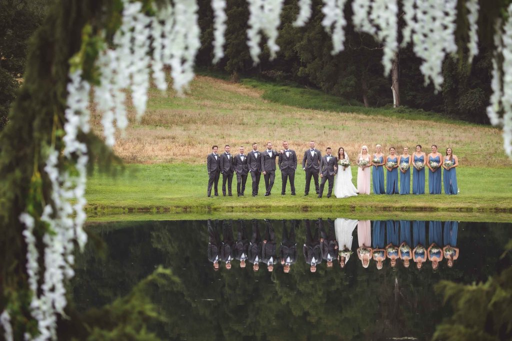 A wedding portrait in front of a pond.