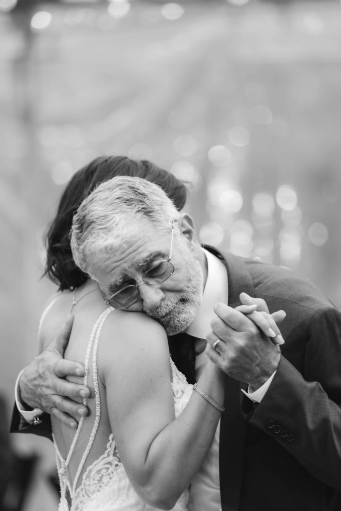 A bride and groom embracing during their wedding reception.