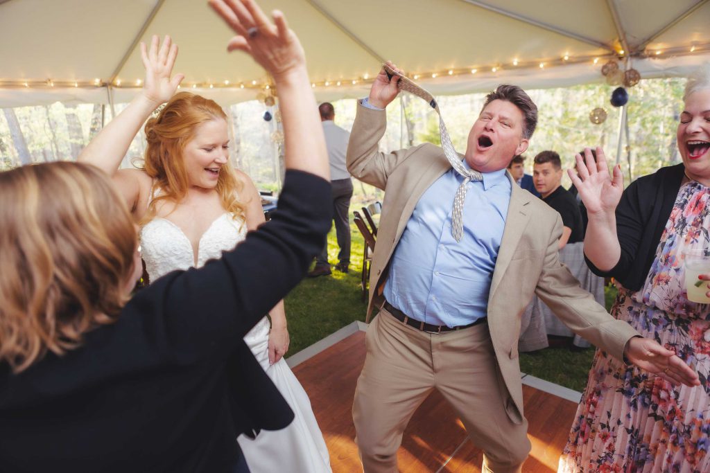 A bride and groom dancing at the reception of their wedding.
