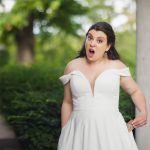 A surprised bride in a white wedding dress.