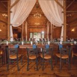 A detailed wedding reception set up in a barn.