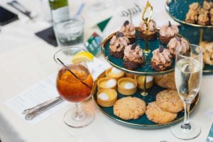 A detailed tray of desserts and drinks at a wedding reception.