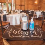 A bottle of water sits on a table at a wedding reception, highlighting the details.