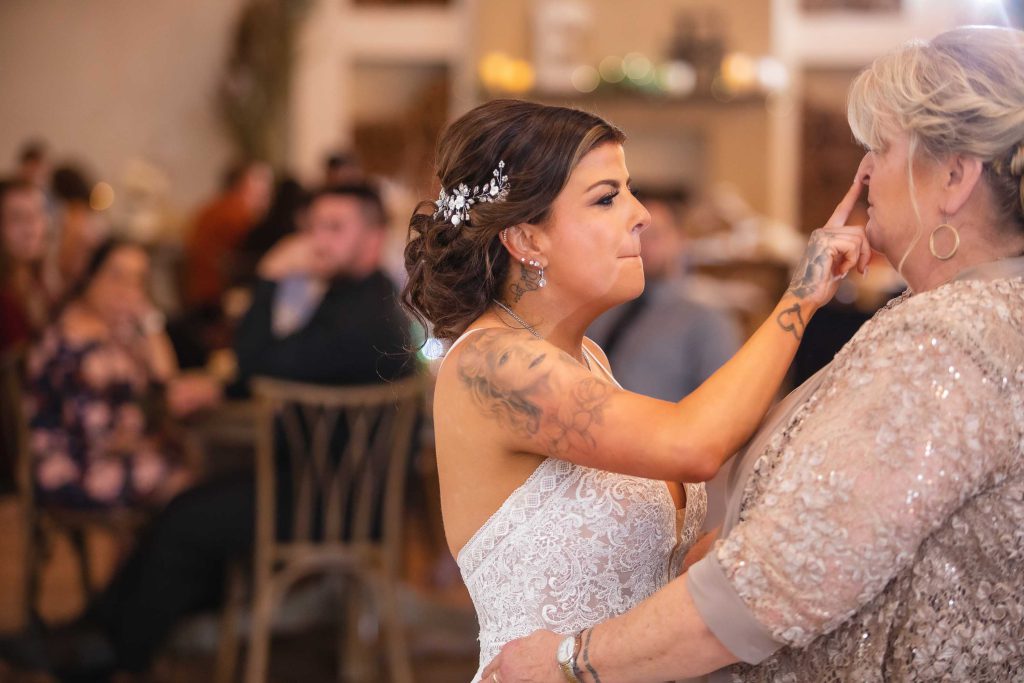 A bride and her loved ones celebrate at a wedding reception gathering.