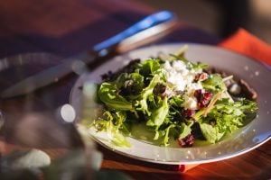 A wedding plate with a salad on it.