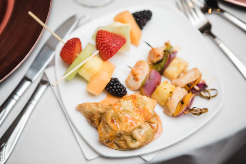 A plate with skewered fruit for a wedding reception.