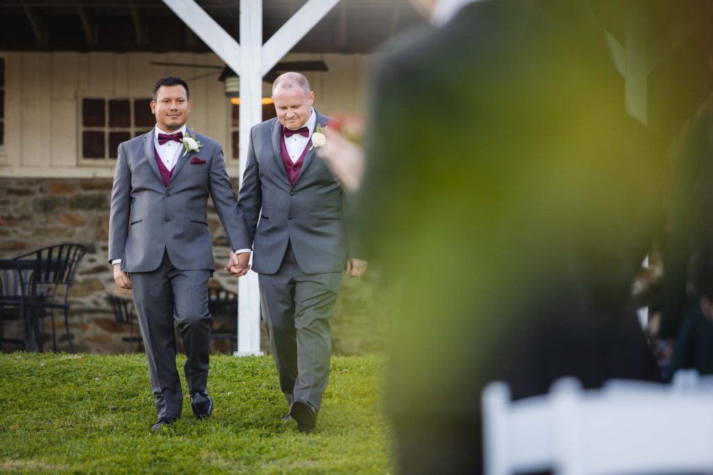 Two grooms participating in a wedding ceremony.
