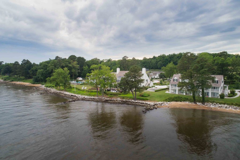 An aerial view showcasing the details of a house on the shore of a lake.
