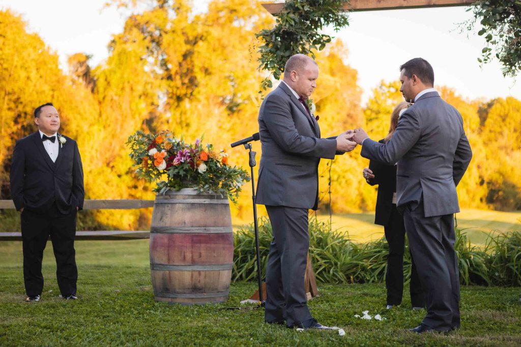 Two men exchanging rings at a wedding ceremony.