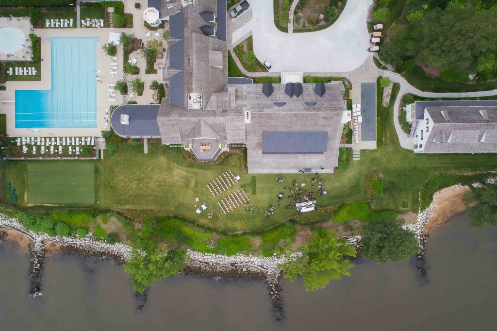 An aerial view of a house with a swimming pool and wedding details.