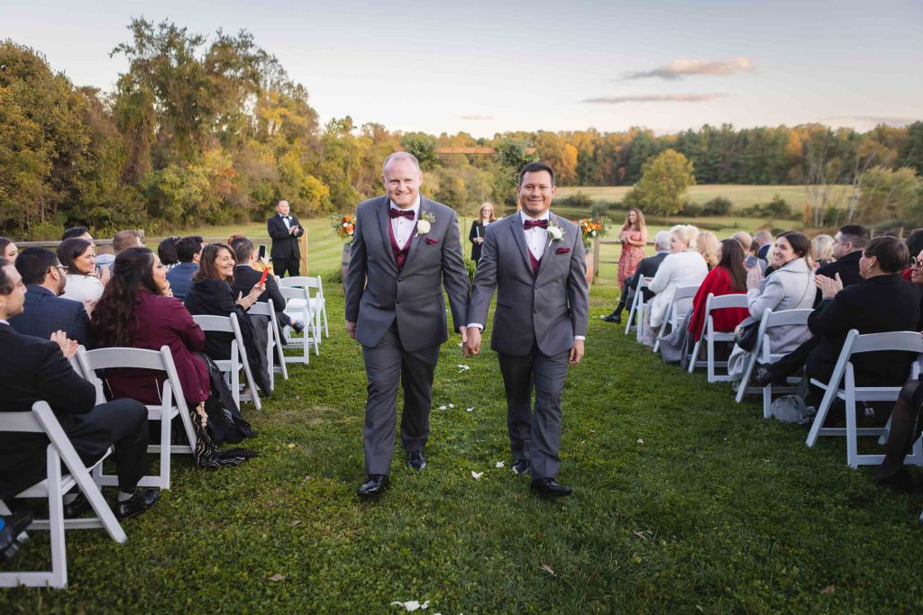 Two grooms having a wedding ceremony.