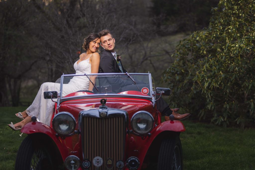 A vintage car wedding portrait.