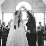 Black and white photo of bride and groom sharing their first dance at their wedding reception.