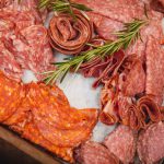 A tray full of different kinds of meats for a wedding event.