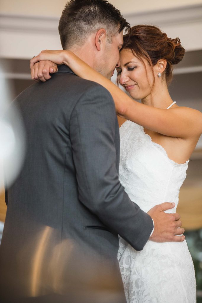 A bride and groom embracing during their wedding reception.