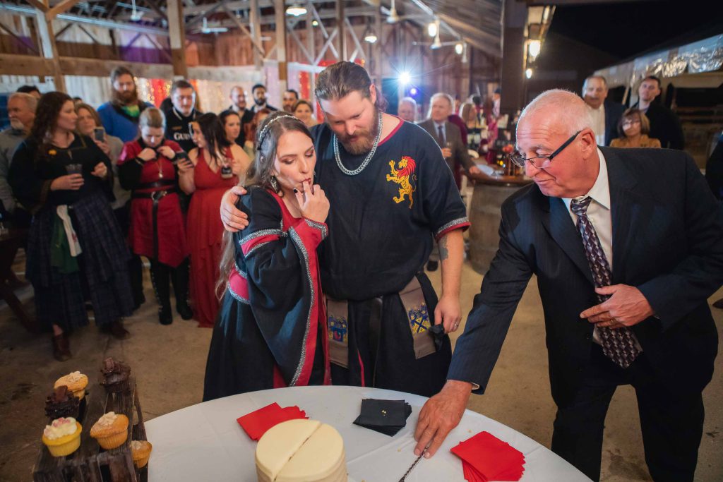 A couple cuts a wedding cake at their reception.