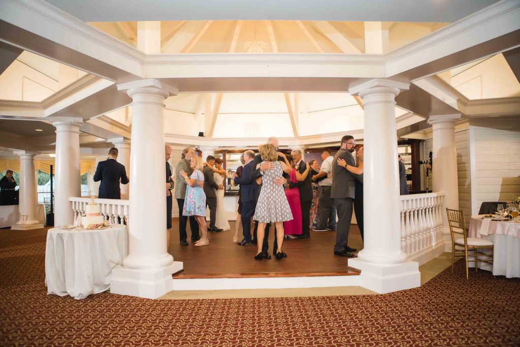 A group of people dancing at a wedding reception.