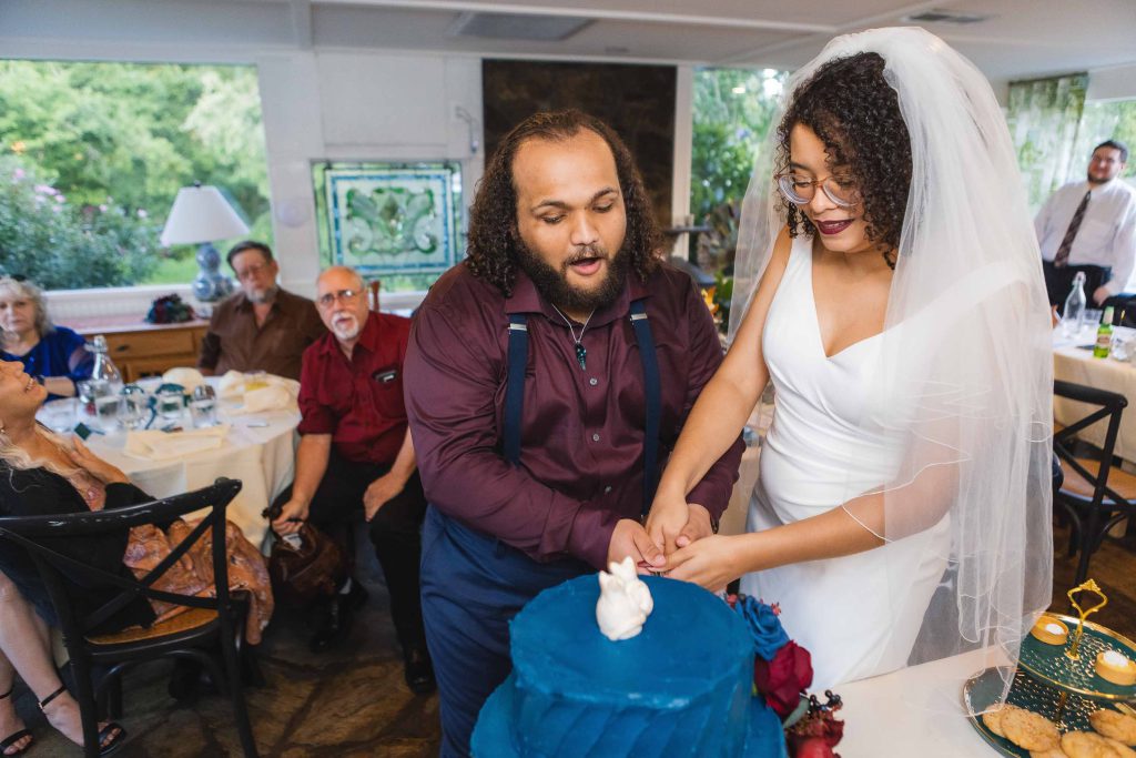 A couple cutting their wedding cake at their reception.
