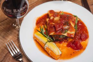 A plate of lasagna with details.