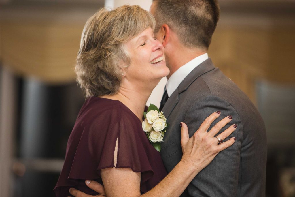A couple embracing at a wedding reception.