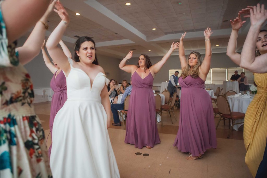A group of bridesmaids dancing at a wedding reception.