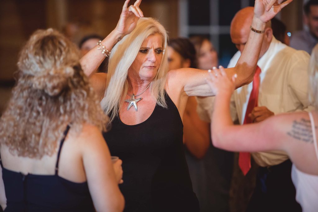 A woman dancing at a wedding reception.