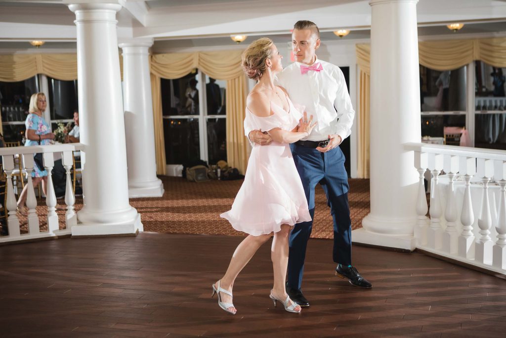 A newlywed couple dancing at their wedding reception.