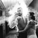 A Wedding portrait of a bride and groom with smoke coming out of their mouths.