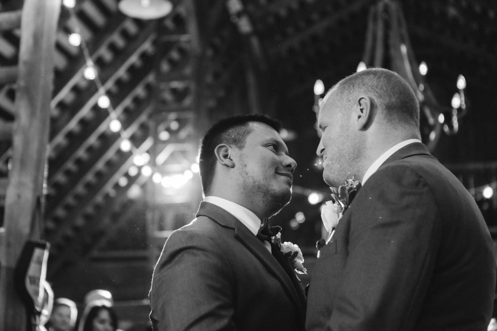 Two grooms have a wedding ceremony.