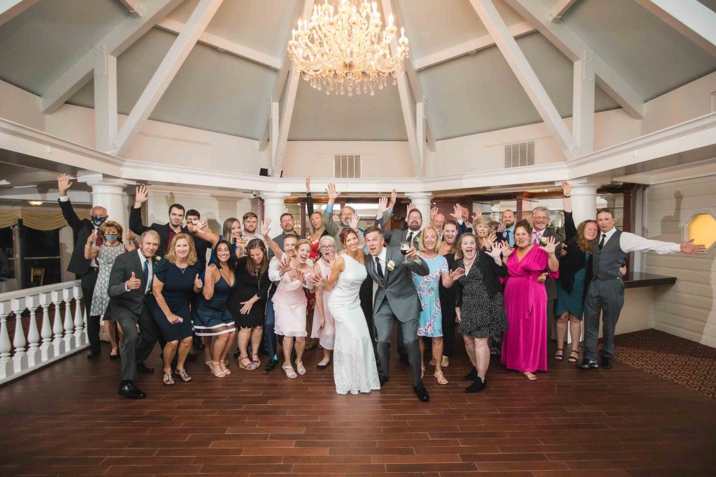 A portrait of a wedding party in a ballroom.