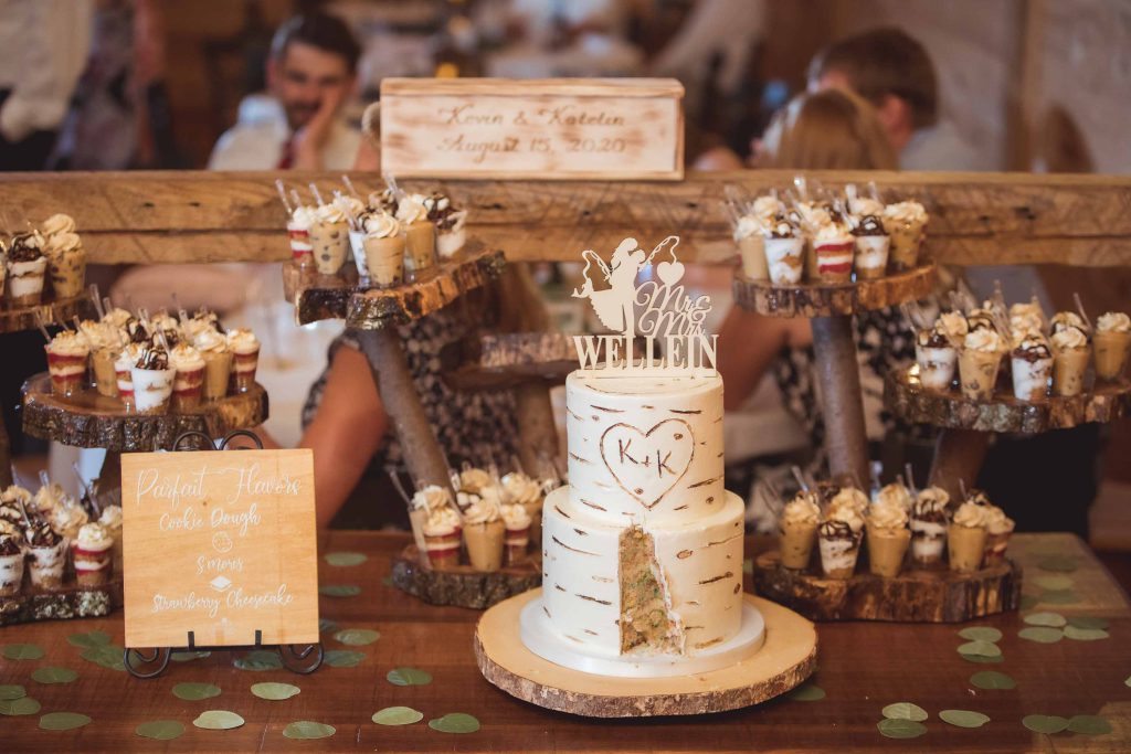 A detailed wedding cake is sitting on a wooden table.